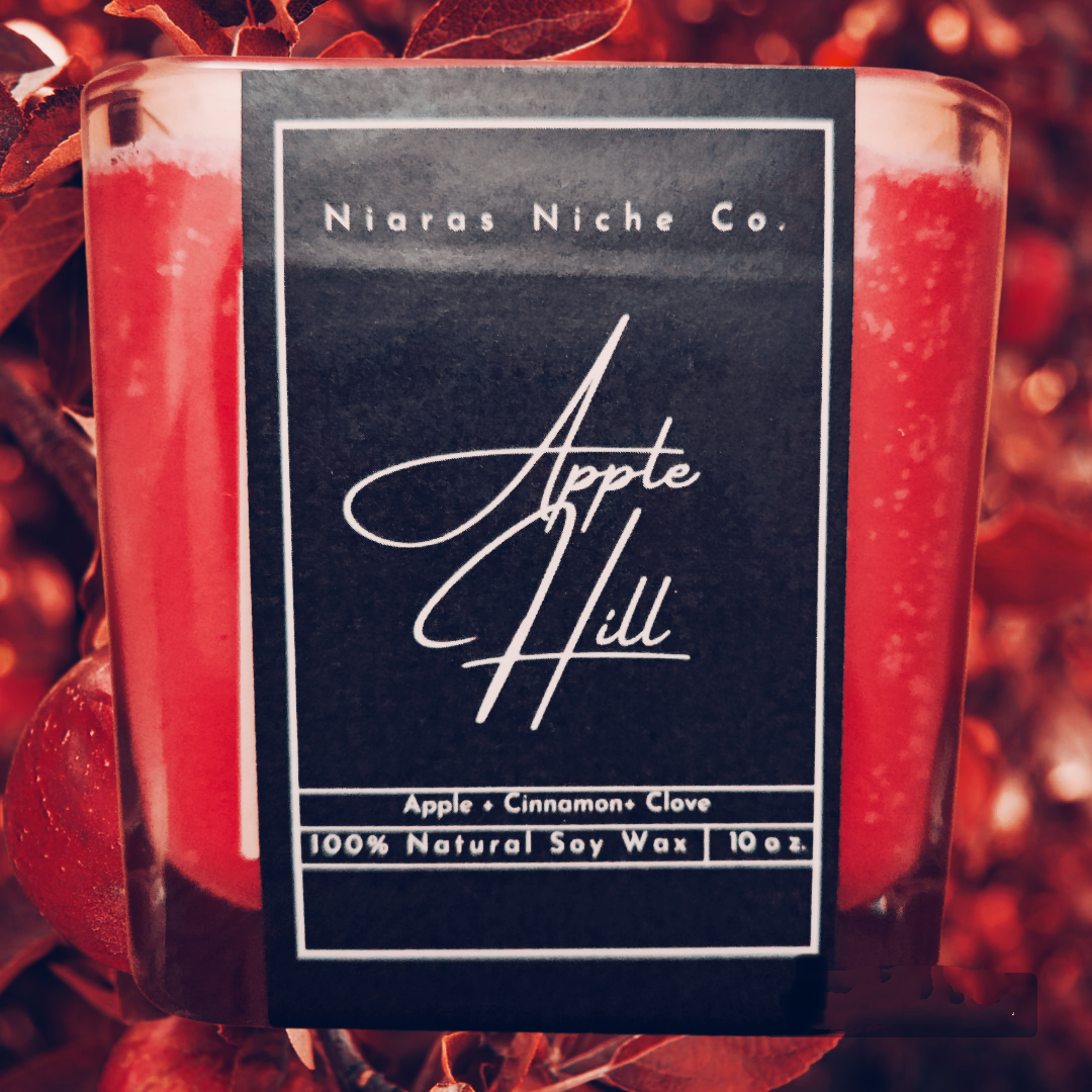 Niaras Niche Co. Apple Hill 10oz candle in glass jar with apple, cinnamon, and clove scent; made with natural soy wax.