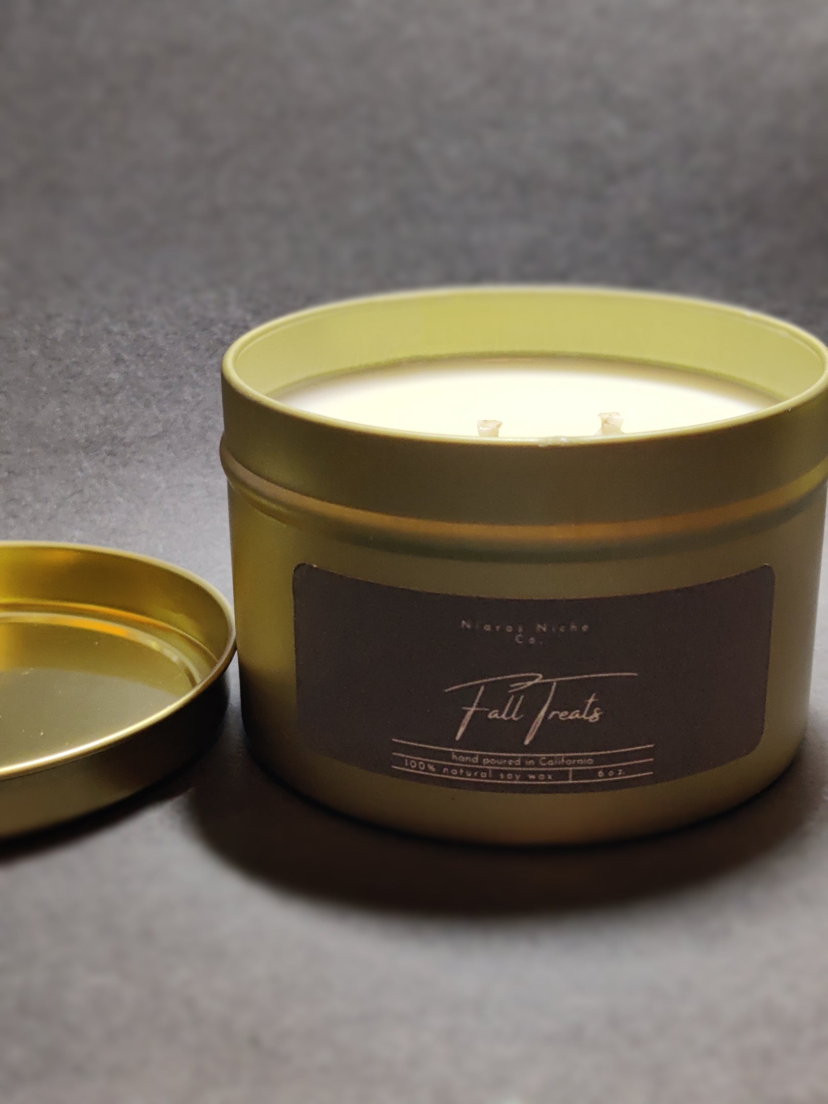 Natural Niche Fall Treats candle in a green tin, handcrafted with 100% soy wax for autumn-inspired fragrance.