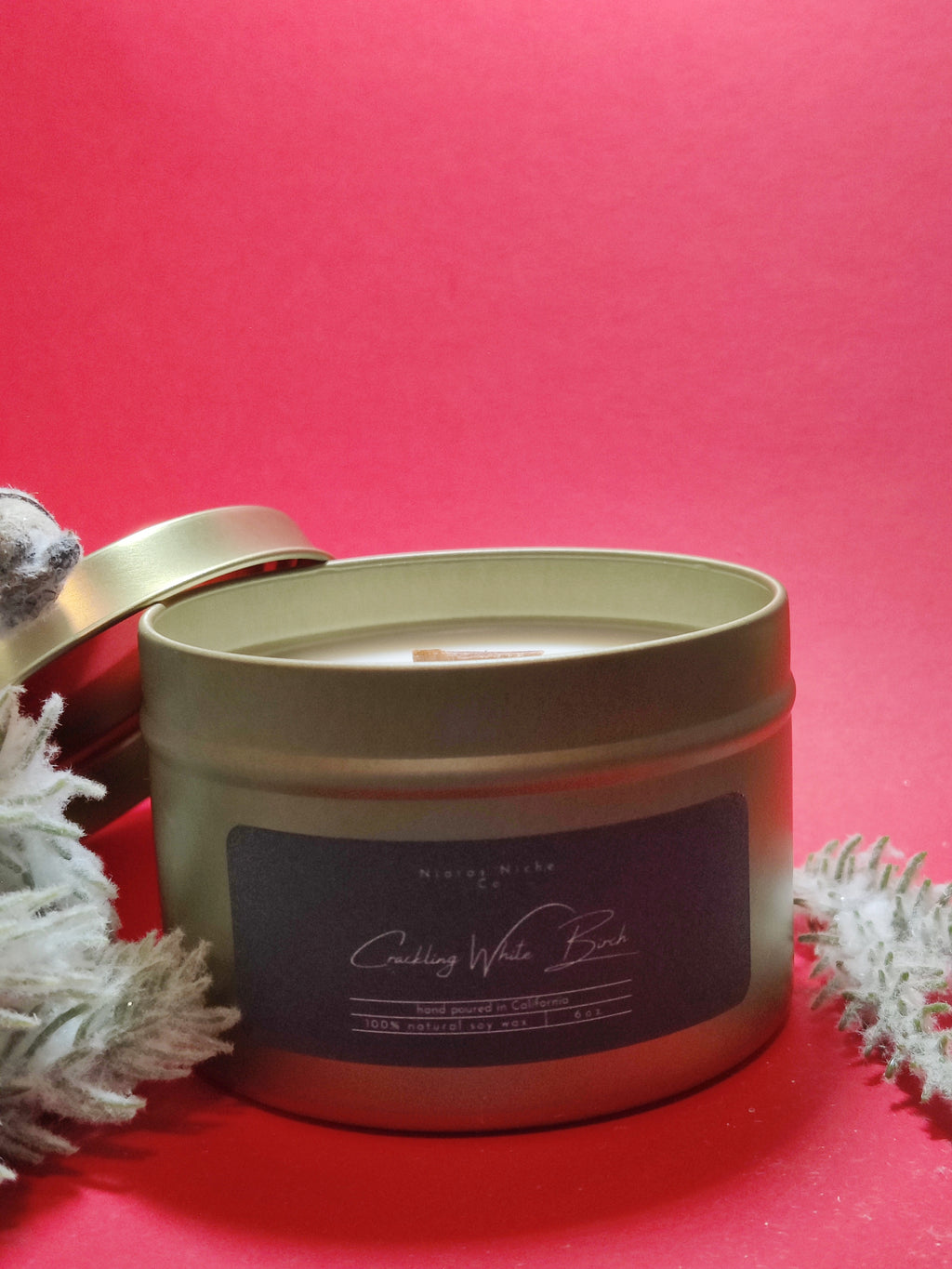 Gold tin candle labeled 'Crackling White Birch', made of 100% natural soy wax, hand poured in California.