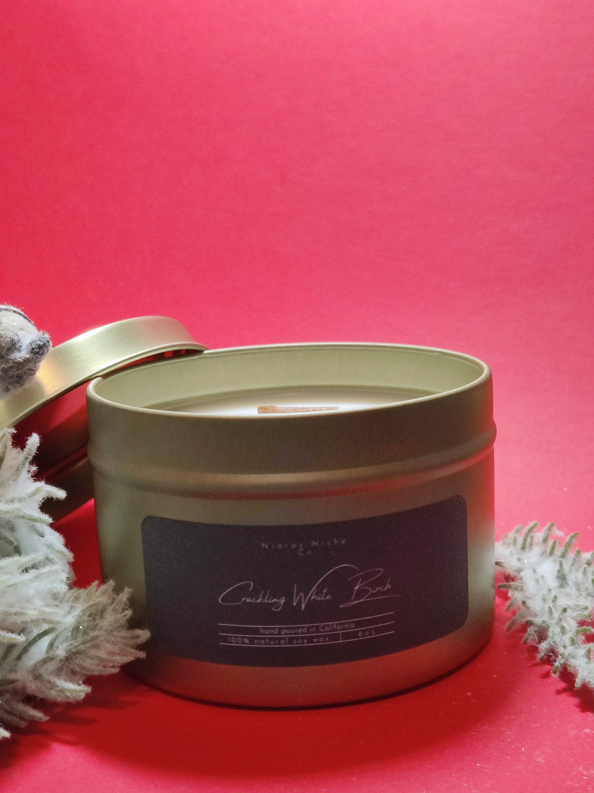 Gold tin candle labeled 'Crackling White Birch', made of 100% natural soy wax, hand poured in California.