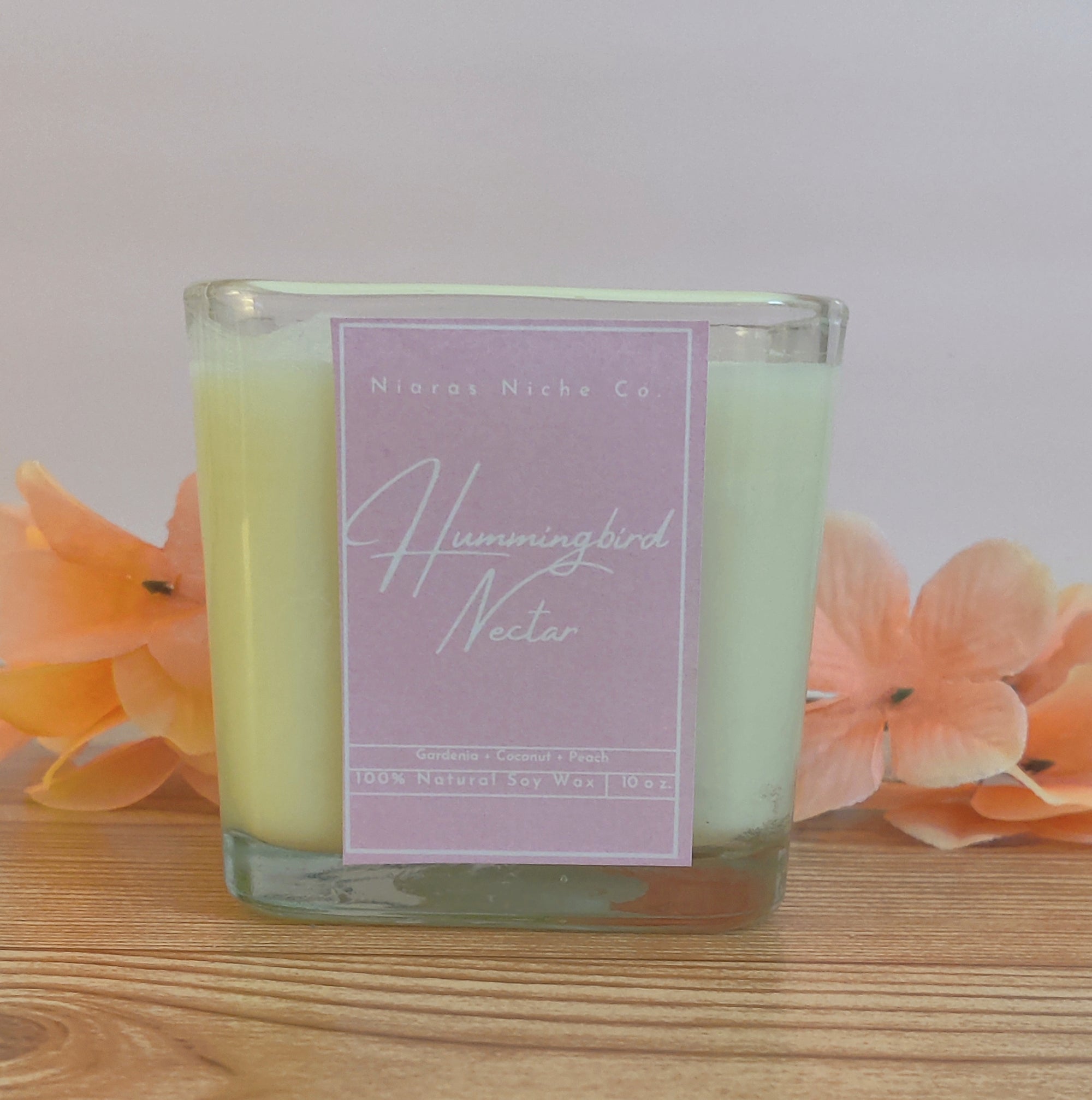 Hummingbird Nectar candle, 100% natural soy wax, blend of gardenia, coconut, and peach, 10 oz in a clear glass jar.